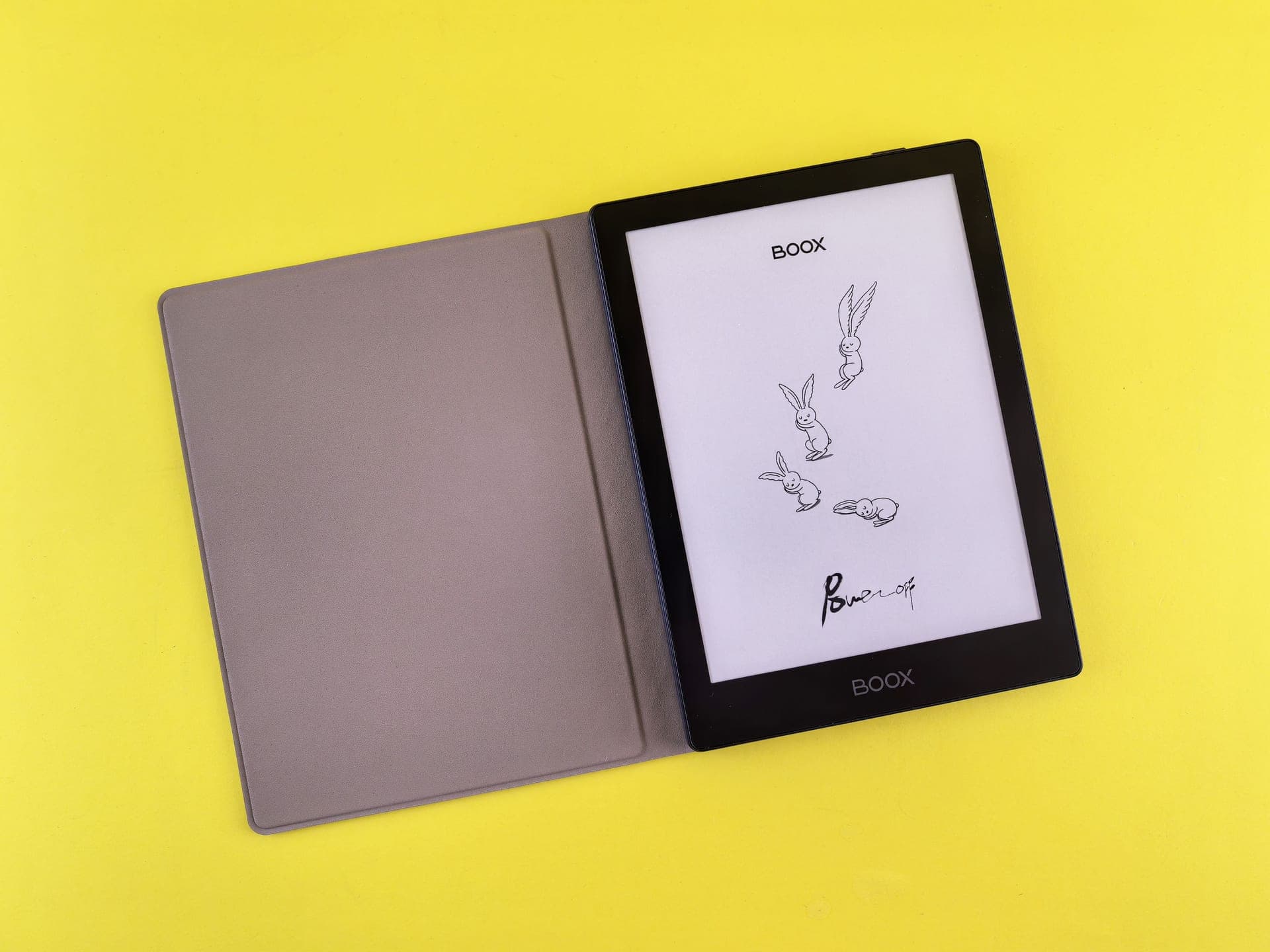An e-reader in a leather case resting on a desk