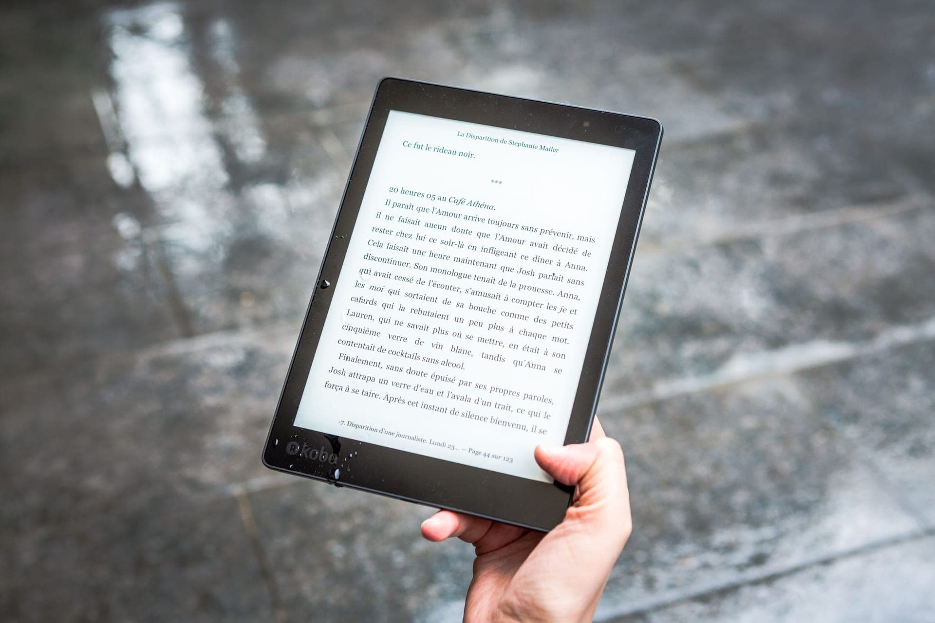 An e-reader held in one hand