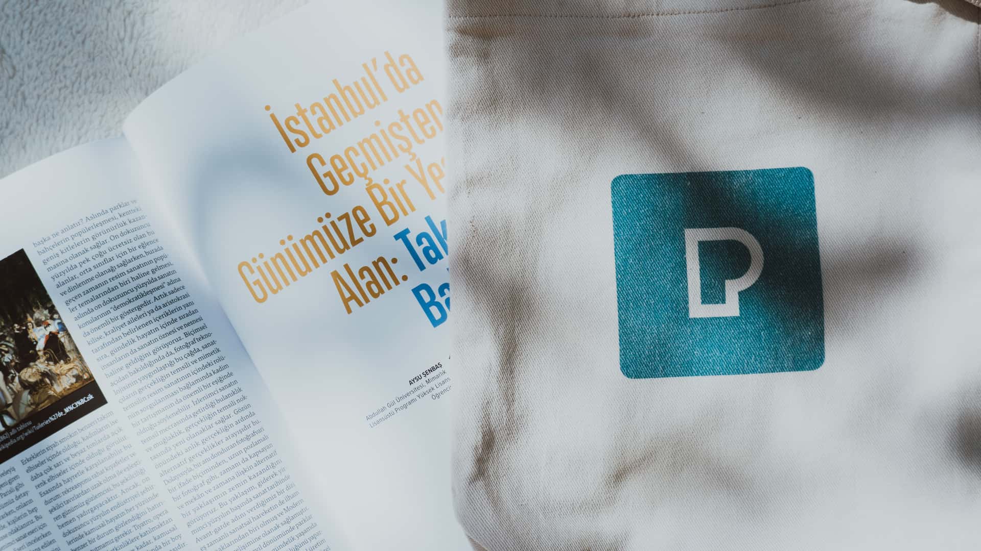 A paperback book tucked inside a canvas tote bag