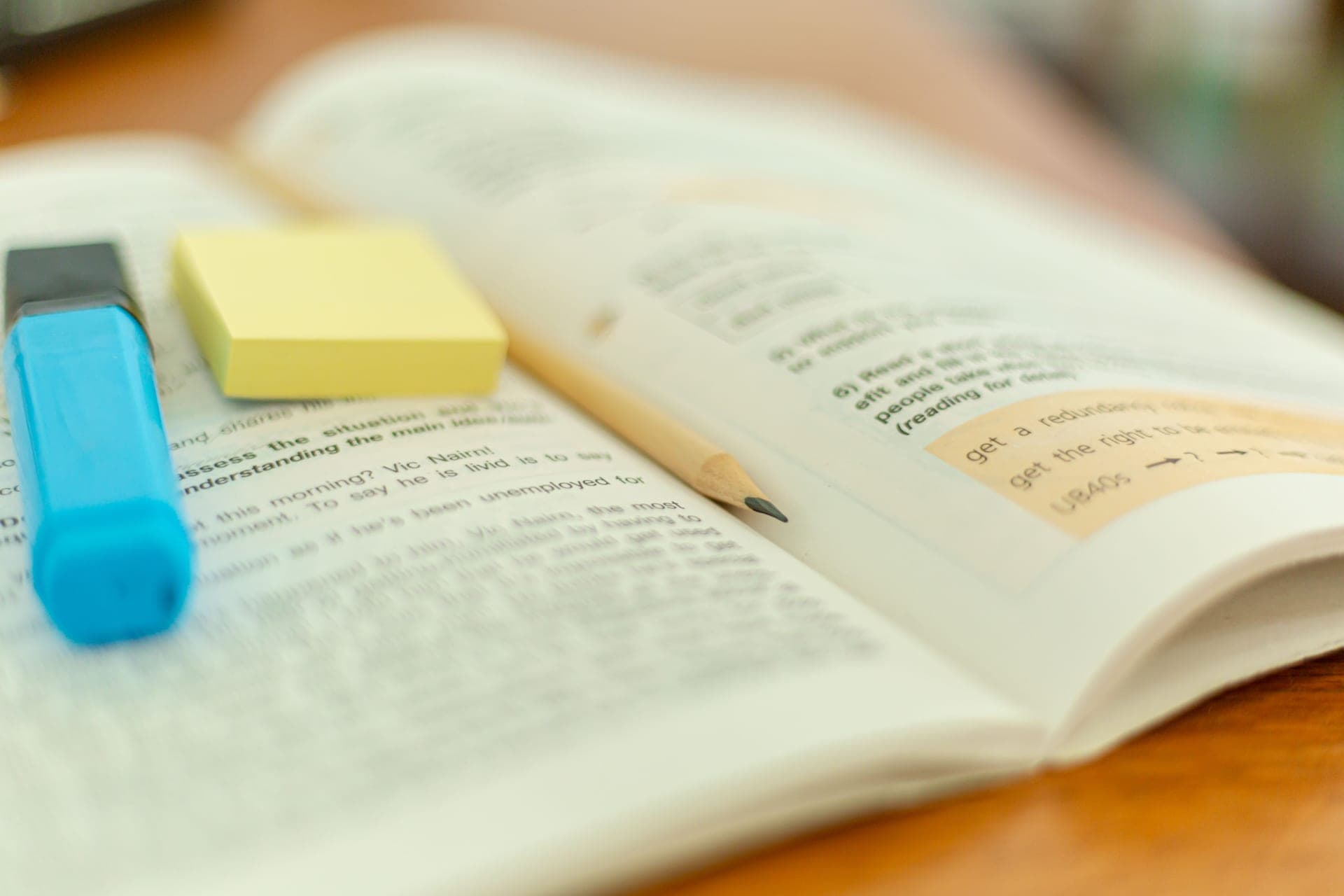 An open textbook and handwritten notes on a study desk