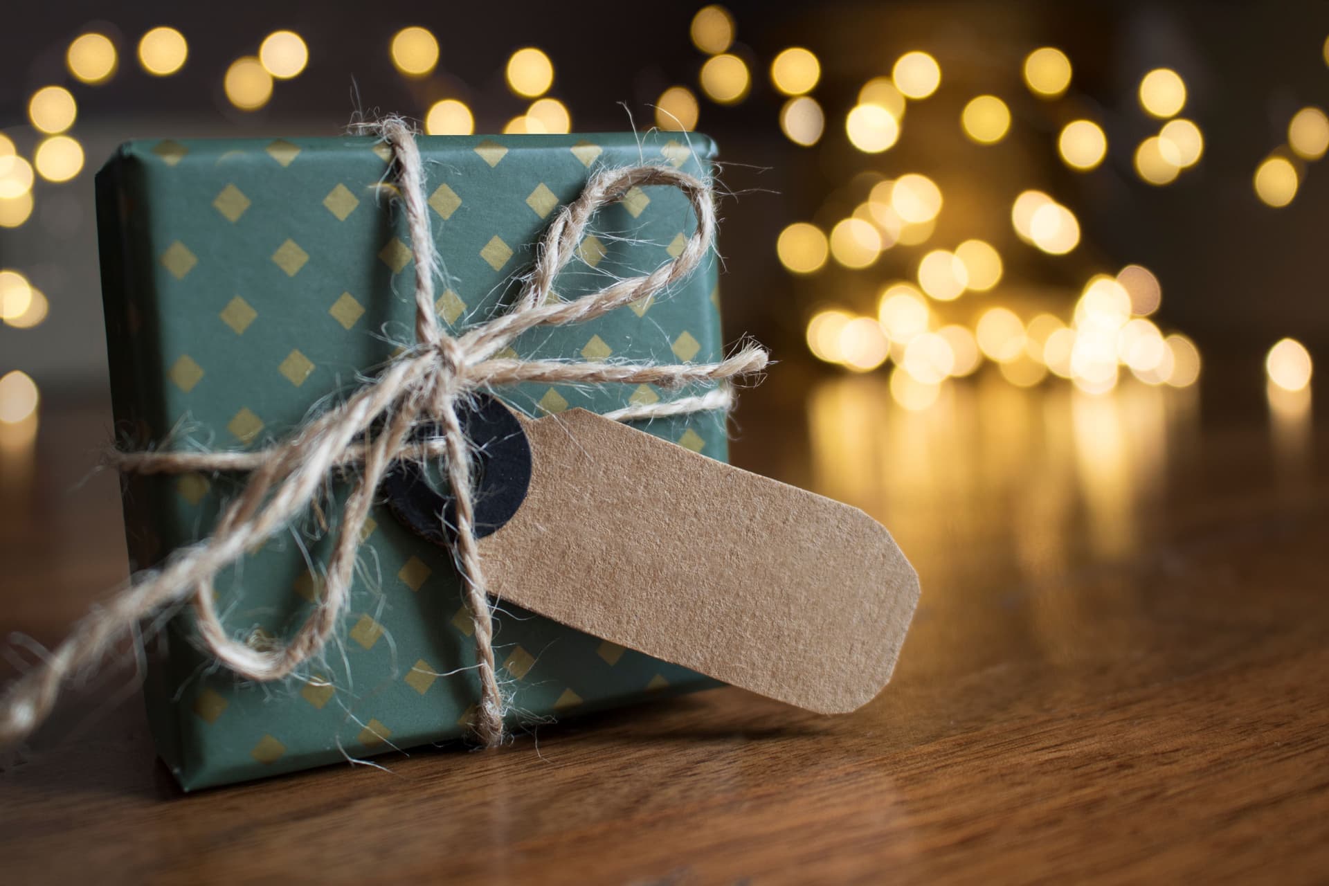 A small gift wrapped in brown paper and tied with twine