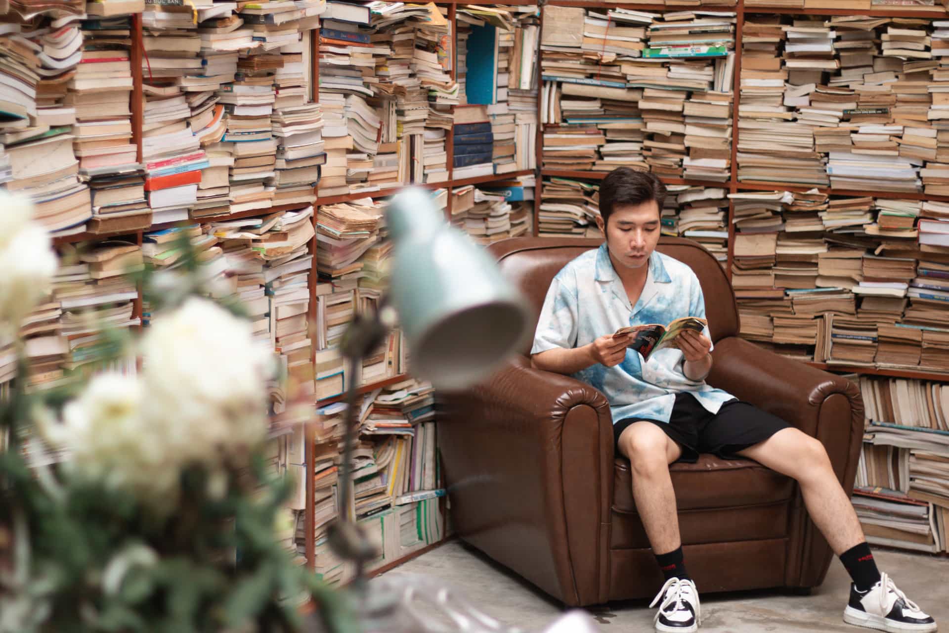A man reading a book in an armchair