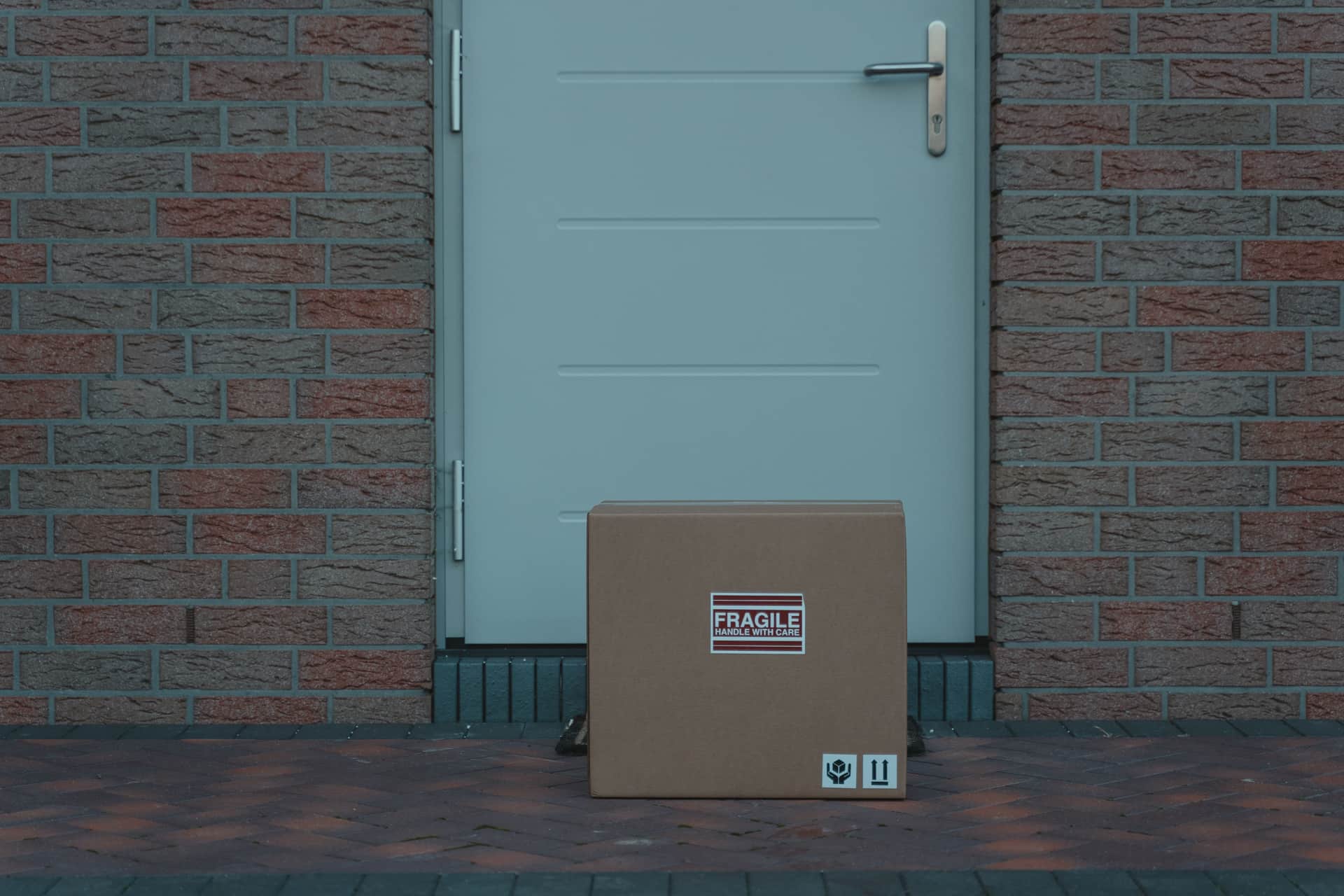 A cardboard parcel box sitting on a doorstep
