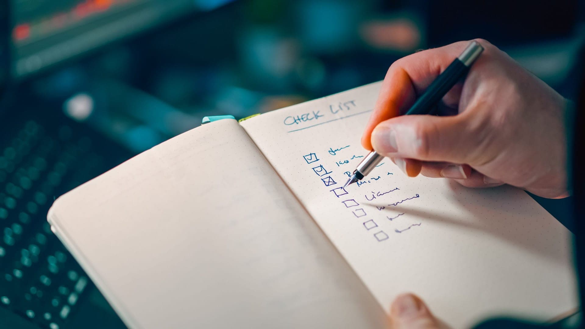 An open notebook with a handwritten checklist