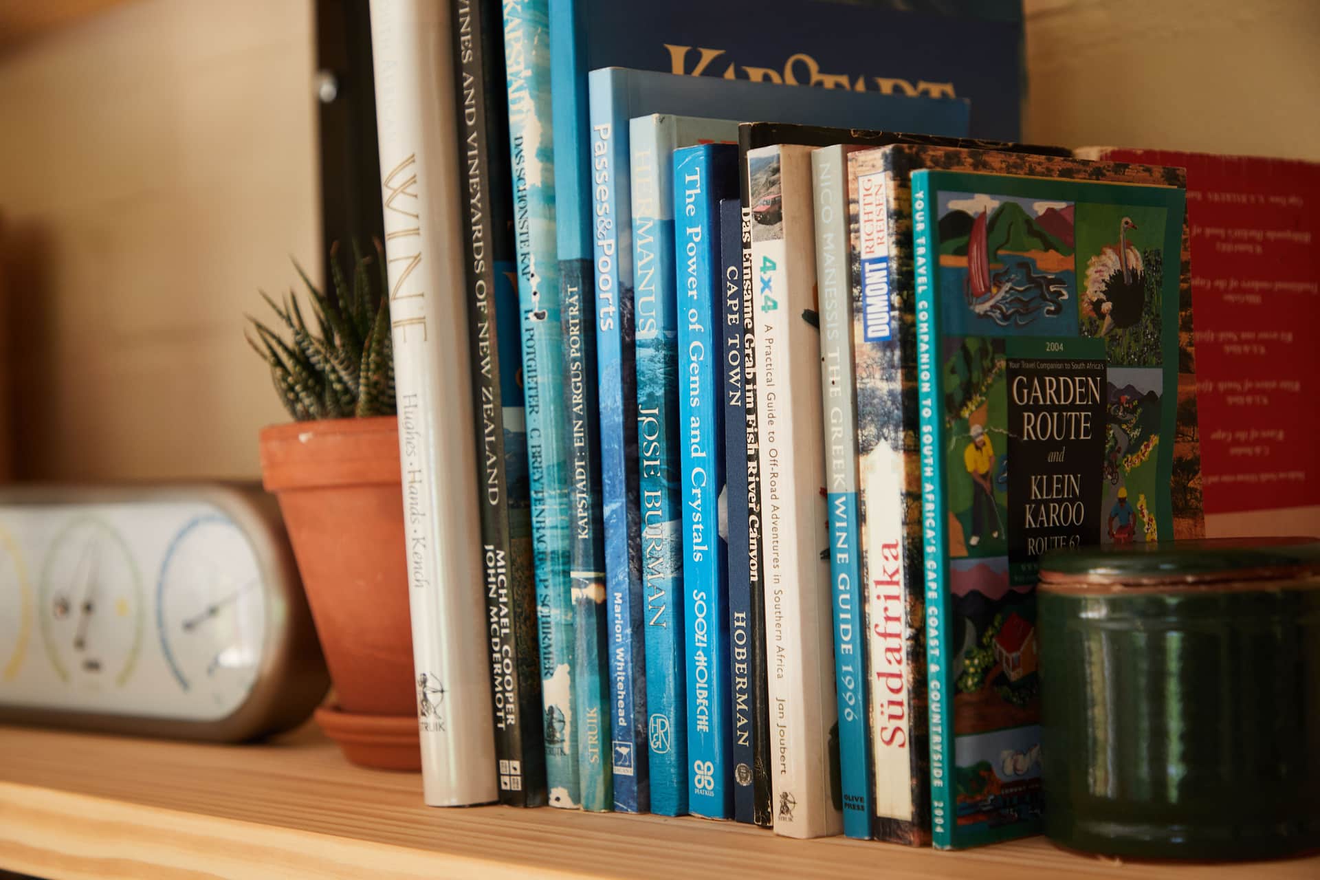 A simple wooden bookshelf holding rows of books