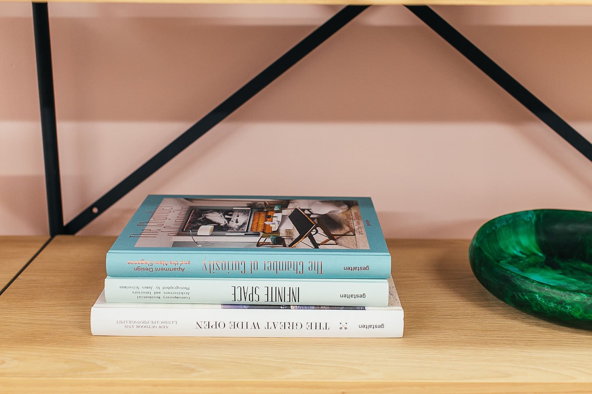 A styled bookshelf with books and small objects arranged together